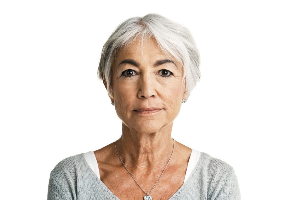 portrait of elderly women posing against a white background